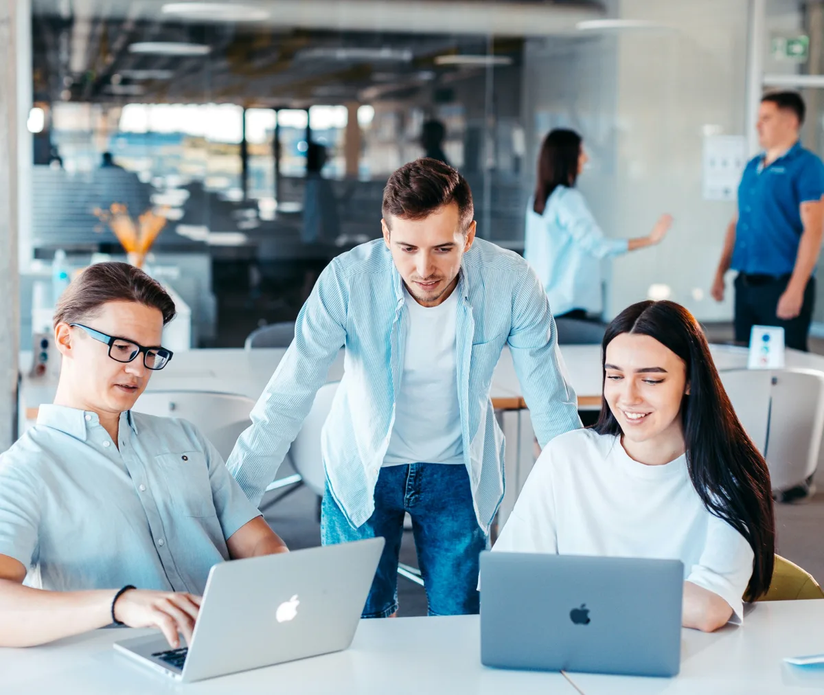 Three colleagues looking at results on a laptop together